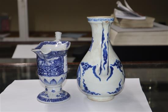 A Chinese Kangxi period blue and white wine pot and a Qianlong period helmet shaped milk jug Height of pot 16cm